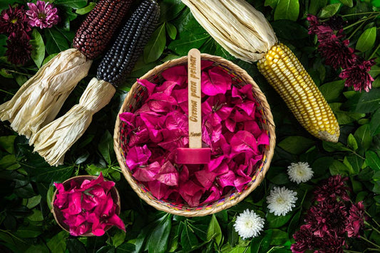 Bugambilia Combing Cream is in a handmade bowl with pink leaves and flowers around it