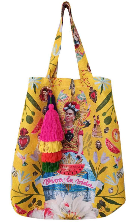 Viva la vida yellow tote bag with a Frida Kahlo illustration in the middle of the bag. It has mexican art ornaments like the famous red heart, hummingbirds, green leaves and a colored keychain