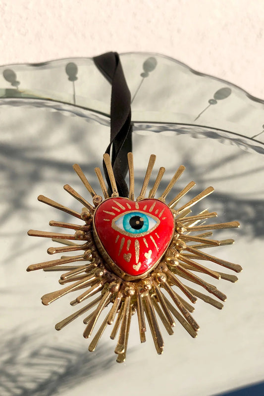 Handmade multicultural necklace in red and gold with an eye in the center.