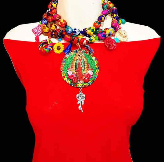 Medallones Choker necklaces with the Virgin of Guadalupe in the center with green background and red roses. The chain is designed by hand with paper mache of different colors with circular shape and hanging elements such as roses, hats.