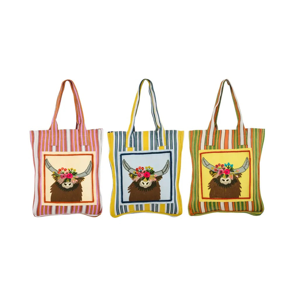 Multicolored recycled plastic tote bag printed with an illustration of a longhorn with a crown of flowers on its head.
