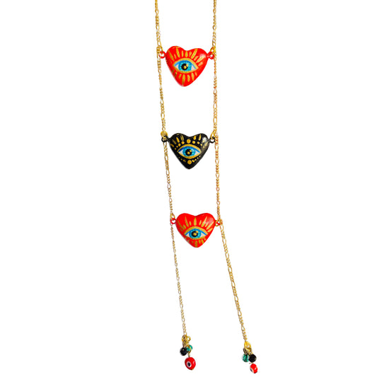 Triple red and black heart necklace with a hand-painted golden eye in the center.