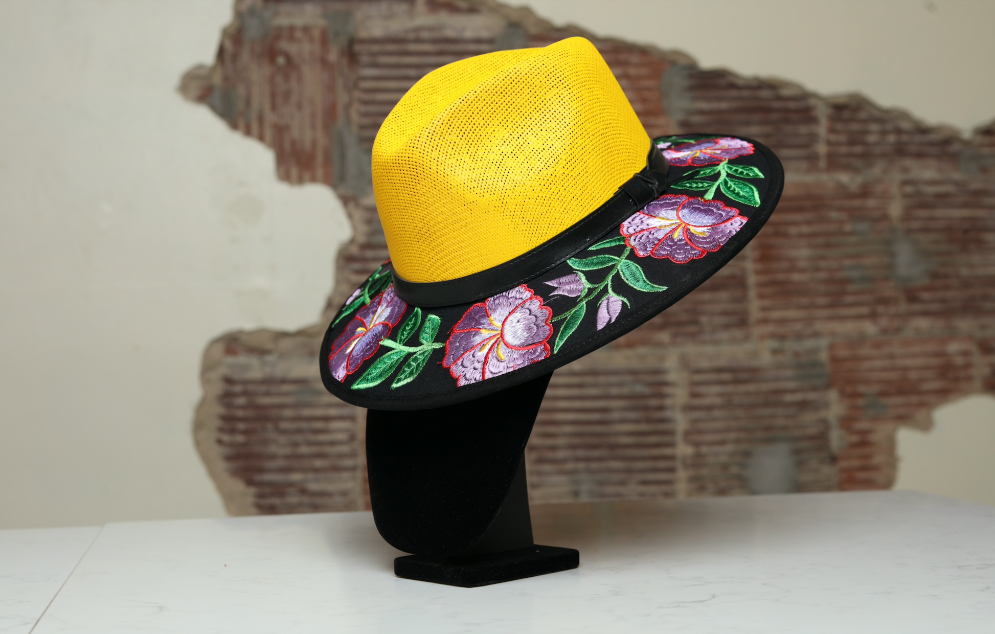 Hand embroidered yellow brimmed hat, the perfect accessory to add fun and style to any outfit. With purple flowers and green leaves as multicultural embellishments.
