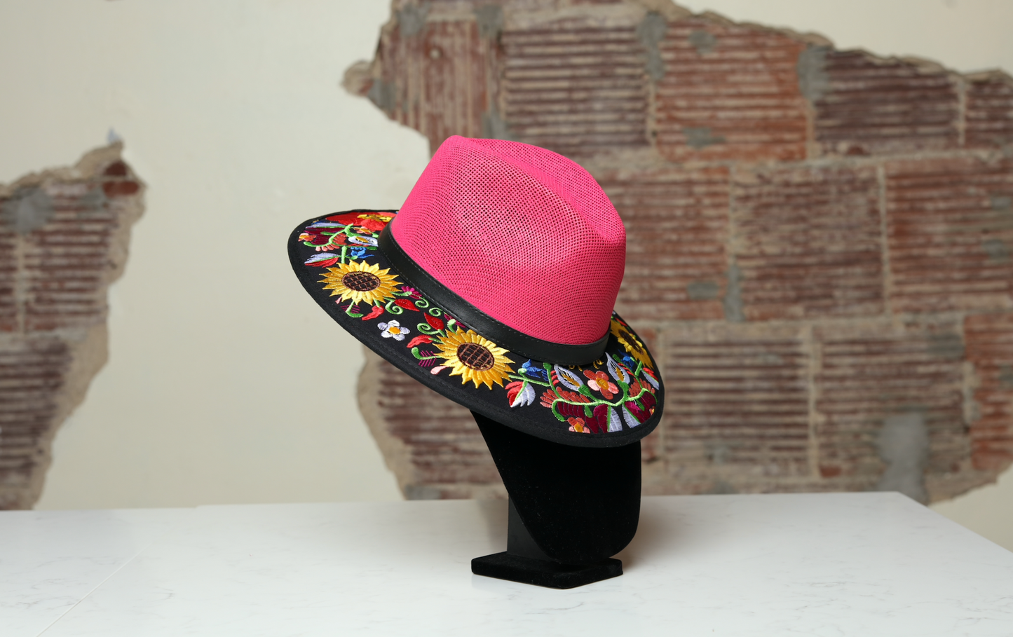 Hand embroidered pink brim hat, the perfect accessory to add fun and style to any outfit. With yellow flowers and green and red leaves as multicultural ornaments.