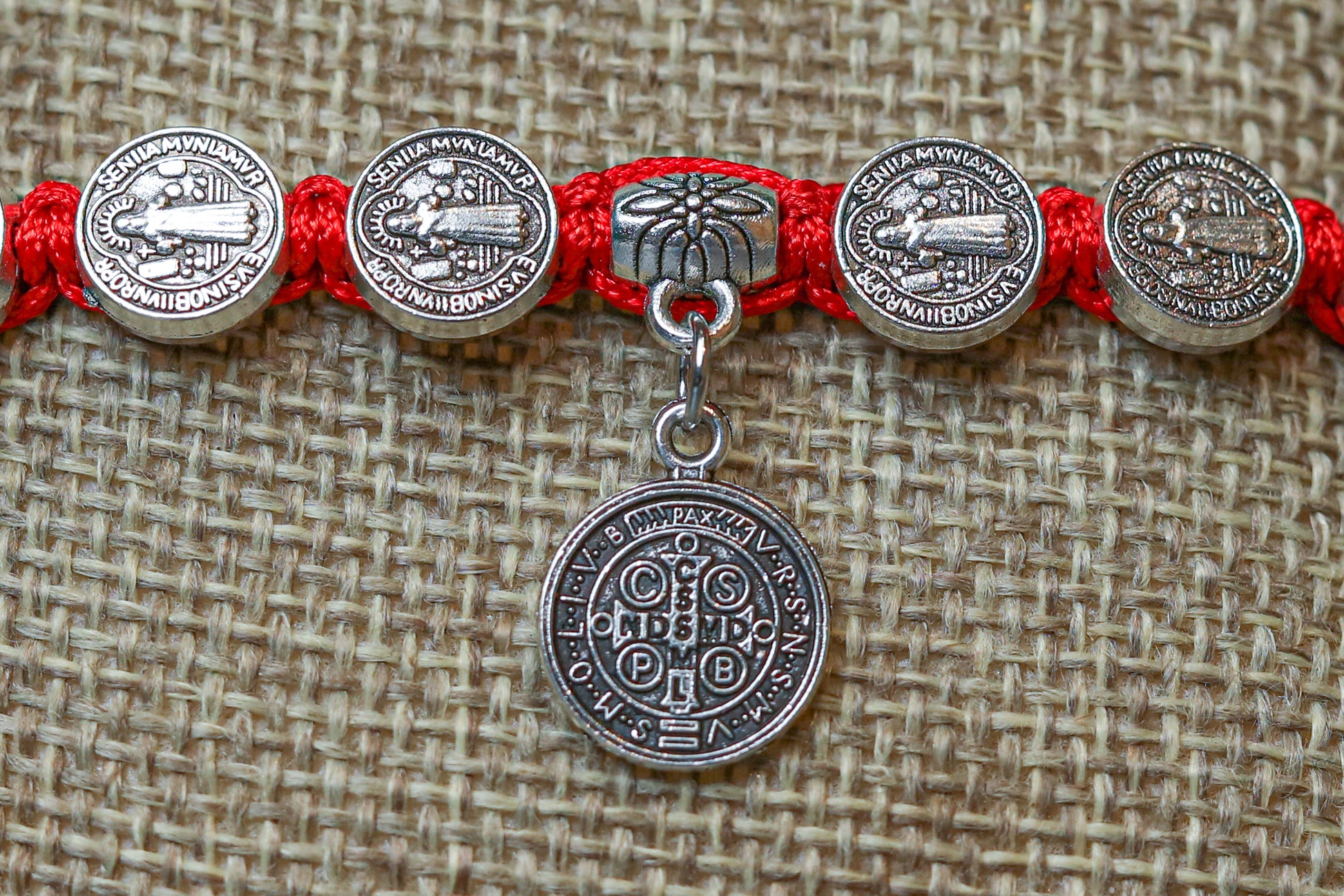 San Juditas charm, a representation of Saint Jude Thaddaeus, the patron saint of desperate cases and lost causes. The charm is believed to provide strength, comfort, and guidance to those who wear it.
