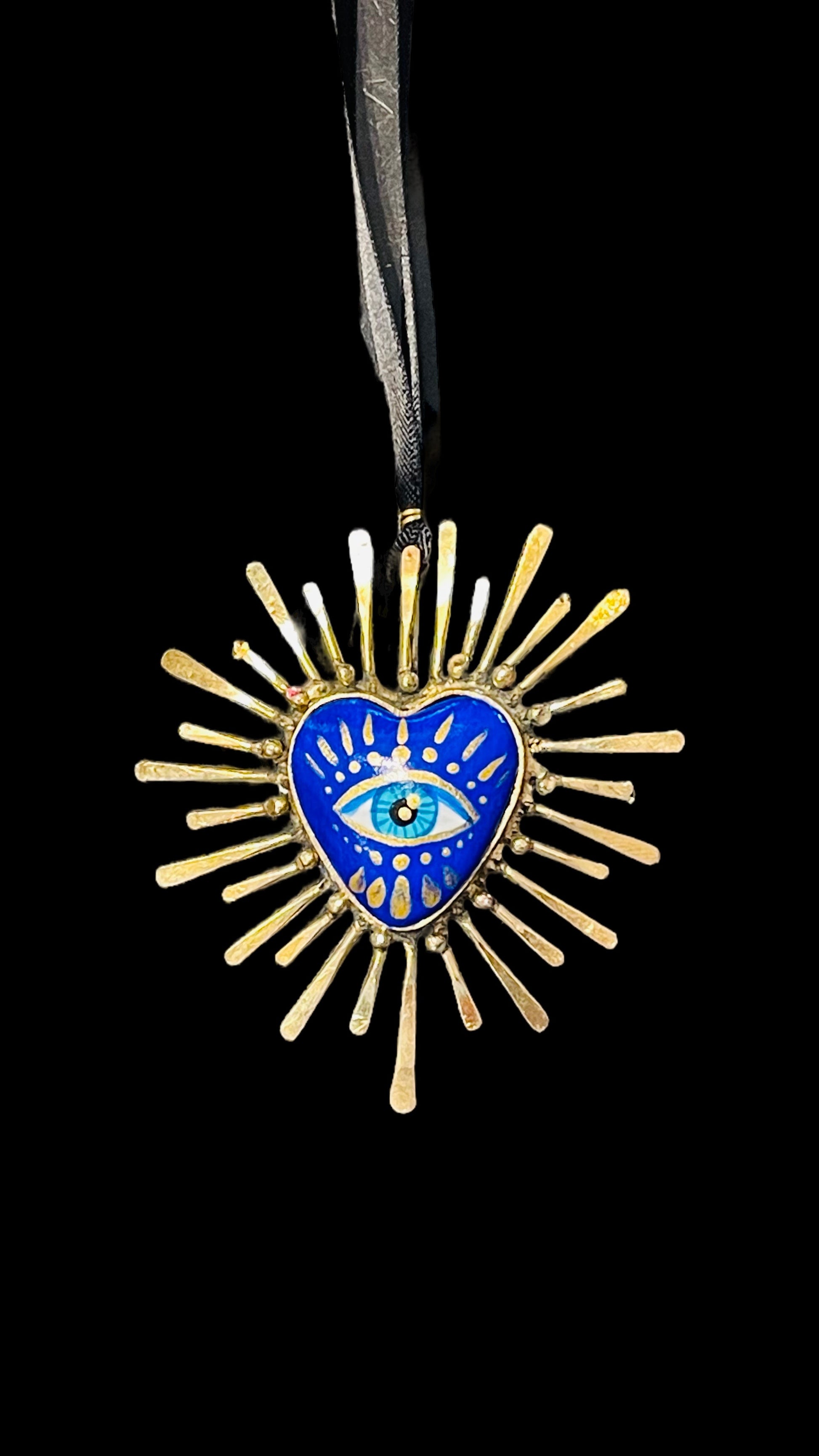 Handmade blue and gold multicultural necklace with painted eye in the center.