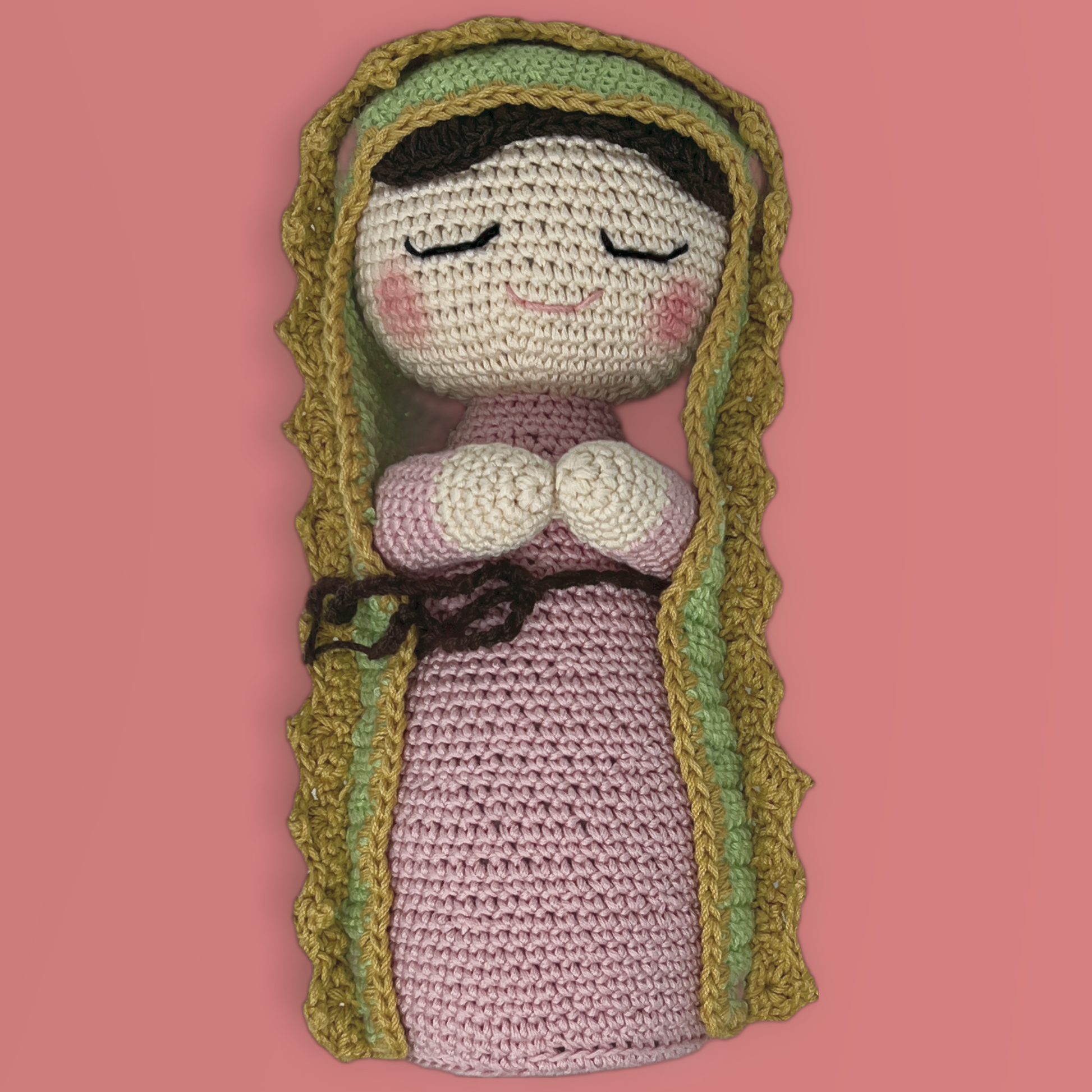 Handmade crochet dolls and is made with pink dress, and green manta crafted by hand