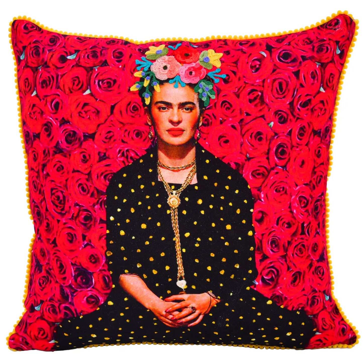 Hand-embroidered pillow with red roses and an image of Frida Kahlo dressed in a black dress with yellow dots. On her head is a wreath of flowers of different colors and the border of the pillow is designed with small yellow pom pons.