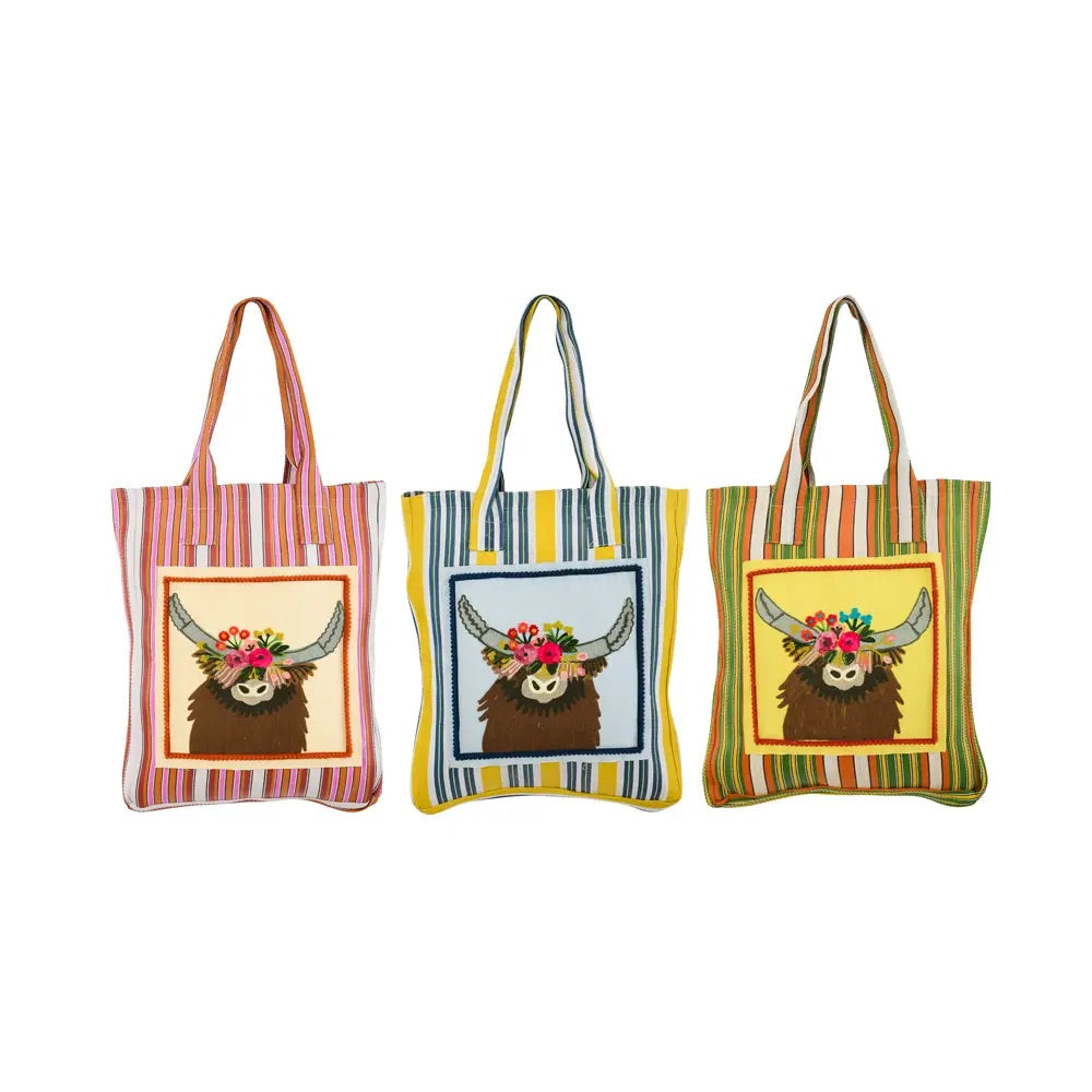 Multicolored recycled plastic tote bag printed with an illustration of a longhorn with a crown of flowers on its head. 